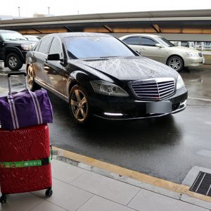 一台車和一個行李在機場外